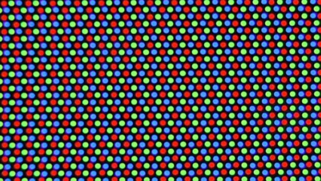 Uma grade de círculos vermelhos, verdes e azuis alternados